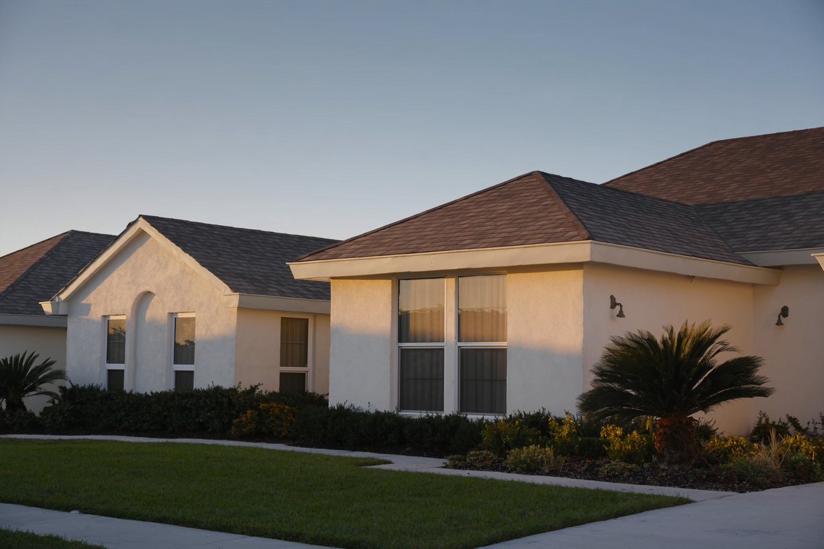 Florida home exterior with concrete tile roof and impact-rated windows in late afternoon light